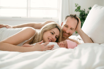 Obraz na płótnie Canvas A family parent with a newborn baby in bed
