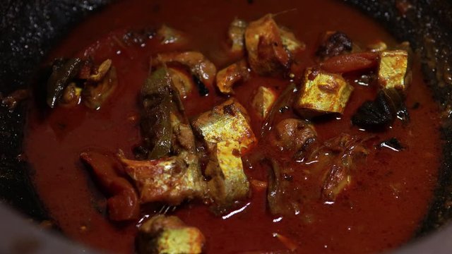 Meen Vattichathu or Pattichathu, sardine fish cooked. Traditional hot and spicy fish curry Kerala India with dried red chilly and green curry leafs. Very popular coastal food eat with tapioca or rice