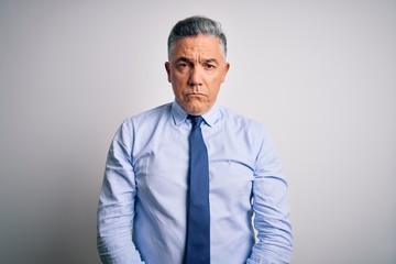 Middle age handsome grey-haired business man wearing elegant shirt and tie depressed and worry for distress, crying angry and afraid. Sad expression.