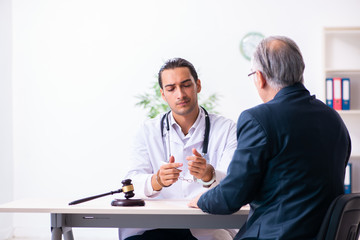 Male doctor in courthouse meeting with lawyer