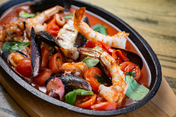 Bowl of seafood, prawns, shrimps, fish, tomatoes