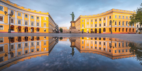panorama of central boulevard in Odessa with monument of city founder Duke with reflections in water in the morning time with copy space