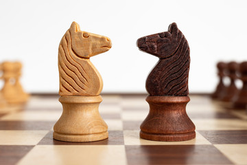 Duel of knight on chessboard. Concept picture taken in studio concerning decision making, strategy...