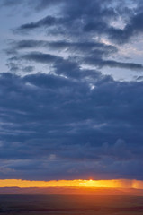 Rain clouds over distant hills at sunset. Zabaykalsky Krai. Russia.
