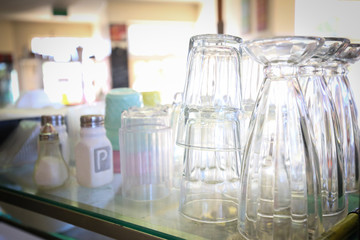 Cafe setting with glasses stacked and salt and pepper shakers