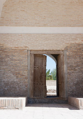 door in the old brick wall- Chor-Bakr Necropolis: ancient graves of Juibar sheikhs, near Bukhara, Uzbekistan...