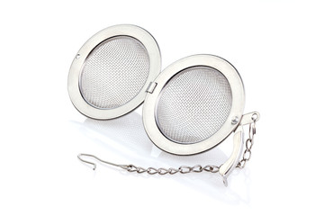 Fototapeta premium Tea strainer on a chain isolated for white background. A tea strainer is a kitchen accessory close-up. Full depth of field.
