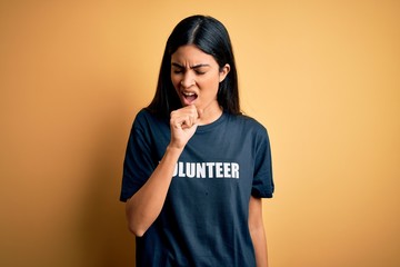 Young beautiful hispanic woman wearing volunteer t-shirt as social charity moral feeling unwell and...