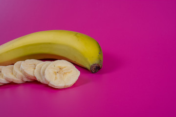 banana with slices in front on background