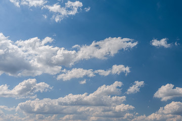 White volumetric clouds on a blue sky.