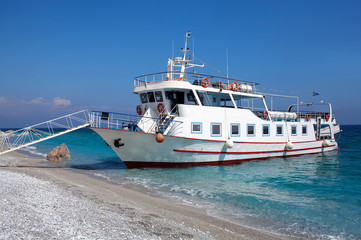 Famous Mediterranean Lalaria beach on Skiathos Greek island with tourist boat on a turquoise sea. Northern Sporades, Greece