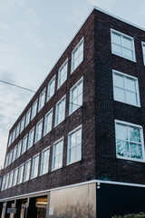 building with dark brick wall in the evening
