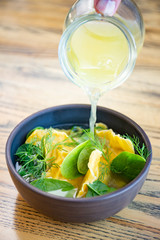 Homemade ravioli with vegetable broth and leaves