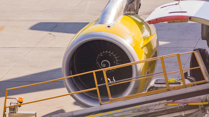 Aircraft being loaded at an airport on a sunny day