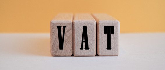 inscription vat on wooden cubes on white background