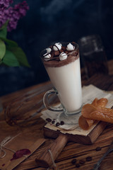Caffe latte on dark moody background with flowers. - 347973981