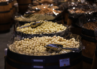 White chocolate balls and other sweets placed in wooden barrels in Hungarian shops.