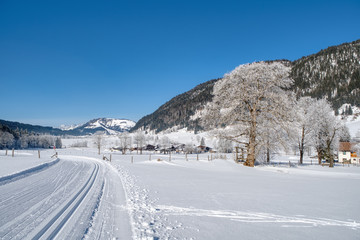 Fototapeta na wymiar Winter mountain landscape with groomed ski trails. Leogang, Tirol, Alps, Austria