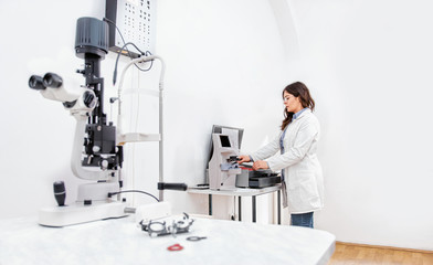 Ophthalmologist preparing an eye examination equipment