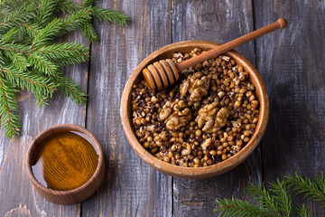 Sochivo, kutya - traditional Slavic holiday ritual dish (Russian, Ukrainian, Belarusian) of whole wheat, poppy, walnuts and honey in wooden bowl on wooden table	