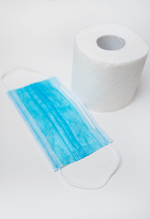 Toilet paper and medical mask. Coronavirus pandemic concept.