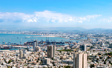 Fototapeta premium Port city with infrastructure on a background of mountains and sea