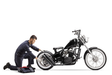 Motorcycle mechanic repairing a chopper motorbike