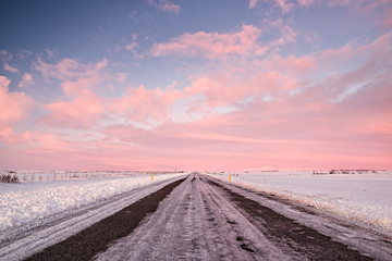 Fototapeta na wymiar Pink sunset in an iced road in Iceland