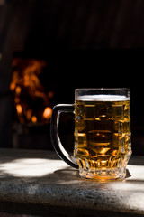 Mug of beer on a black background. The concept of relaxation, bars and parties