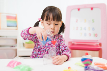 toddler girl making sand animal crafts for homeschooling