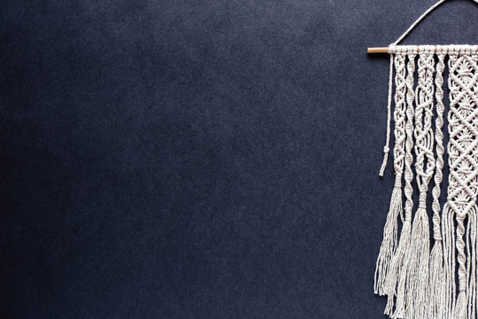 macrame on black background, place for text, banner, flat layout, handmade, hobby, creativity, copy space, top view