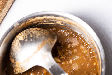 Lentils potage homemade close up still with a metal spoon on a pot