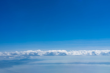 Clouds, Mountain range and coastline with blue sky background