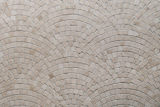 Beige mosaic tile texture on the bathroom wall