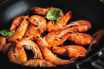 Fried shrimps with spices on pan