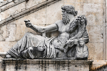 Ancient Statue in front of stairs into Palazzo Senatorio in Rome, Italy.