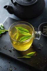 Brewed chinese green tea served in cup on table