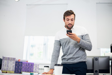 A portrait of a young architect talking to someone over the phon