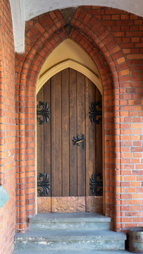 Ancient Gothic Church Portal Carved Wooden Door Church. Large Brown Antique Style Doors Full Frame. Historic Entrance of a Church