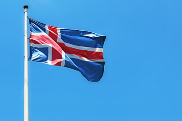 Flag of Iceland on a flagpole. Waving Icelandic Flag Against a Blue Sky. National Flag of Iceland. Image for Icelandic Republic Day, National Day