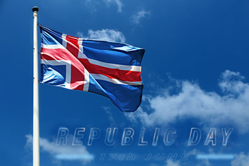Flag of Iceland on a high flagpole and the inscription on the cloudy sky photo - Republic Day, June...