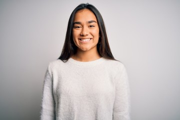 Fototapeta premium Young beautiful asian woman wearing casual sweater standing over white background with a happy and cool smile on face. Lucky person.