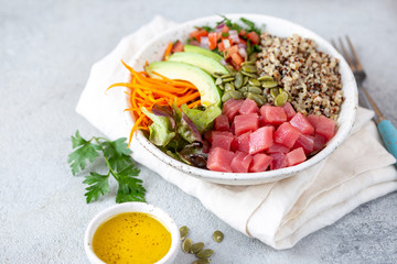 Healthy raw tuna bowl with quinoa and vegetales. Buddha bowl