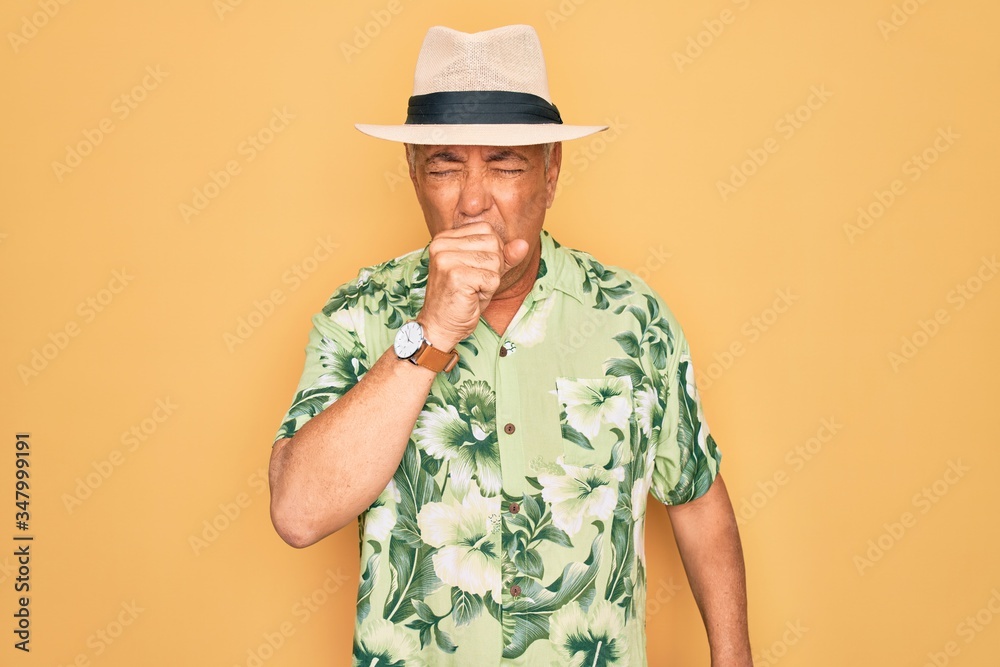 Canvas Prints Middle age senior grey-haired man wearing summer hat and floral shirt on beach vacation feeling unwell and coughing as symptom for cold or bronchitis. Health care concept.