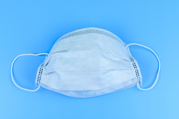 Protective face mask on a blue background. Healthcare and medicine concept