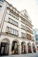 Munich, Germany - May 27, 2019: Hirmer department store in a traditional Bavarian building in downtown Munich