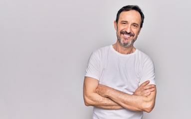Middle age handsome man wearing casual t-shirt standing over isolated white background happy face smiling with crossed arms looking at the camera. Positive person.