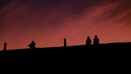 The shadow of the people sitting between them had pillars between them. The sky was magenta