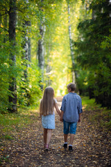 Obraz premium Brother and sister play, laugh, fool around and make grimaces and funny faces together. Little boy and girl, friends, children, kids smile and have fun. Family weekend outdoors.