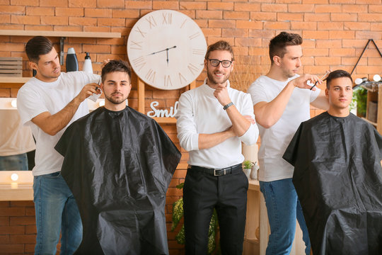 Young men with professional hairdresser during courses in salon